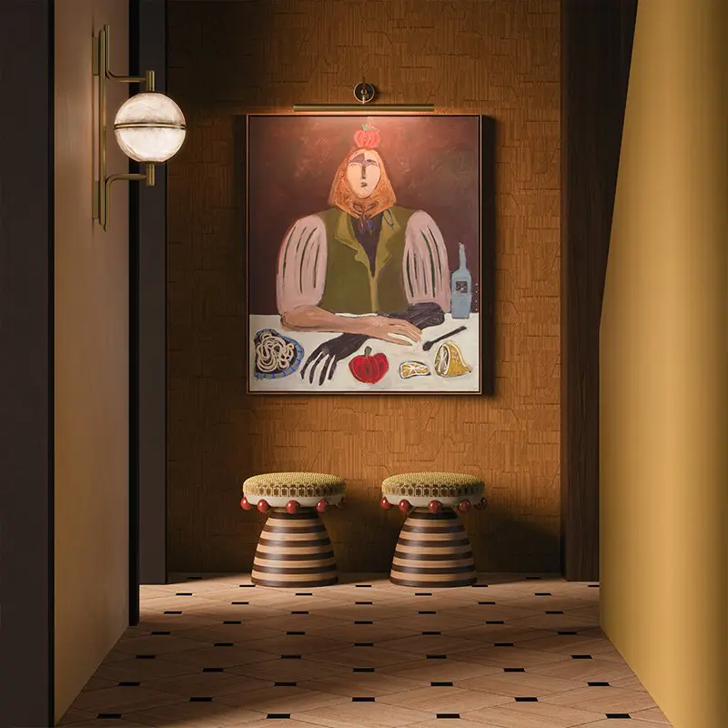Andros Wall Lamp Luxury interior design setting featuring the Andros wall lamp by Creativemary and two Krom Mea stools by Malabar in a warm-toned, artistic hallway with a large central painting.
