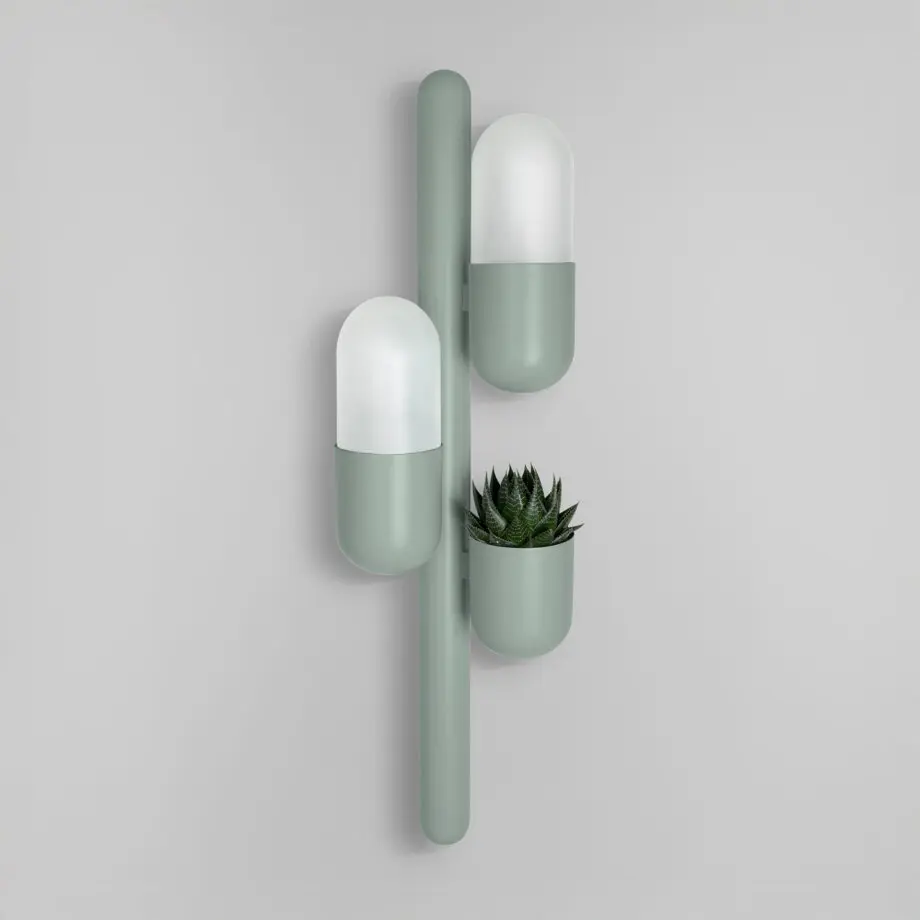 Cactus wall lamp lacquered in ocean green, featuring opal glass and a succulent plant, with the lights turned off.