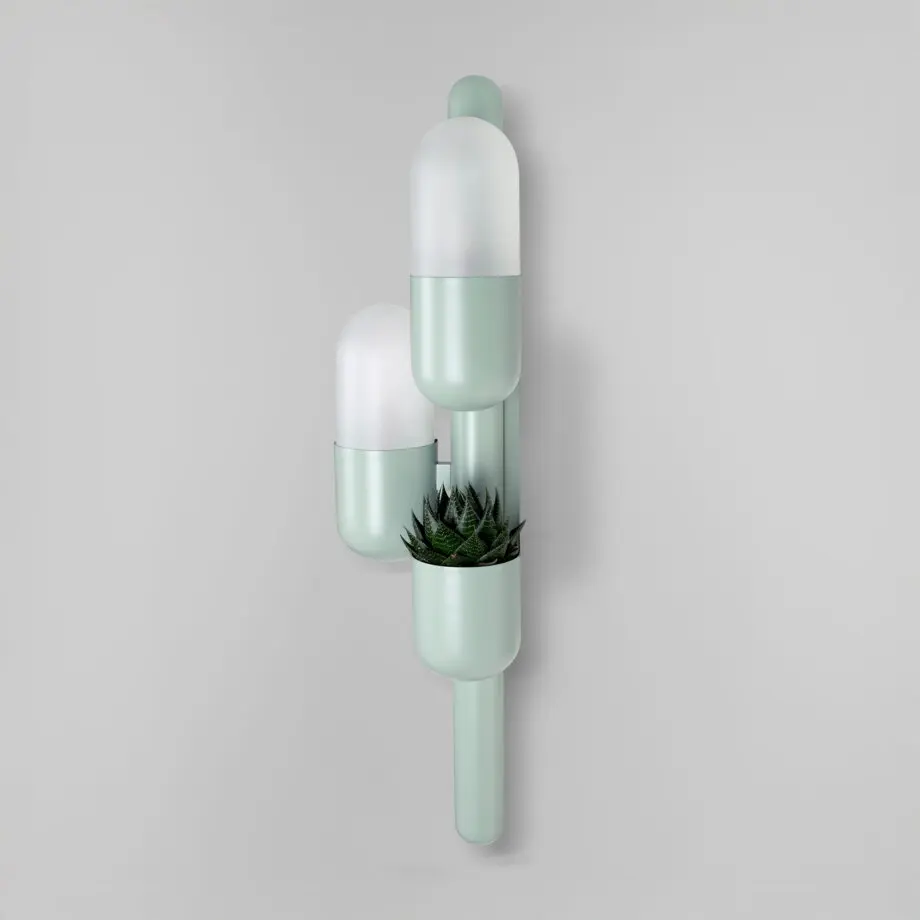 Cactus wall lamp lacquered in cement gray, with opal glass and a succulent plant, shown from the side with the lights turned off.