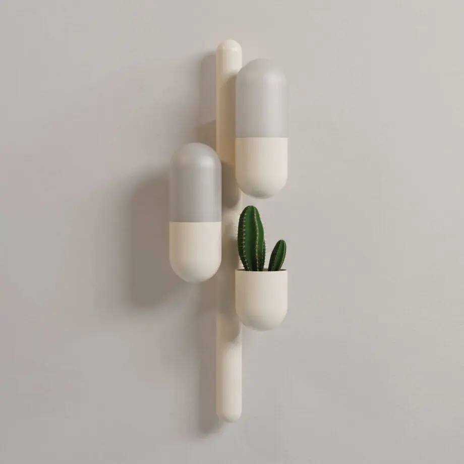 Cactus wall lamp with its two lights turned off, emitting a warm glow, lacquered in cream color with white glass shades. The piece also features a succulent plant.